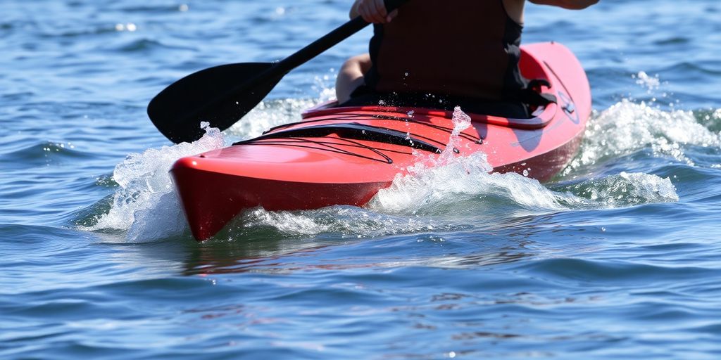 Kayaker paddling smoothly on clear water.
